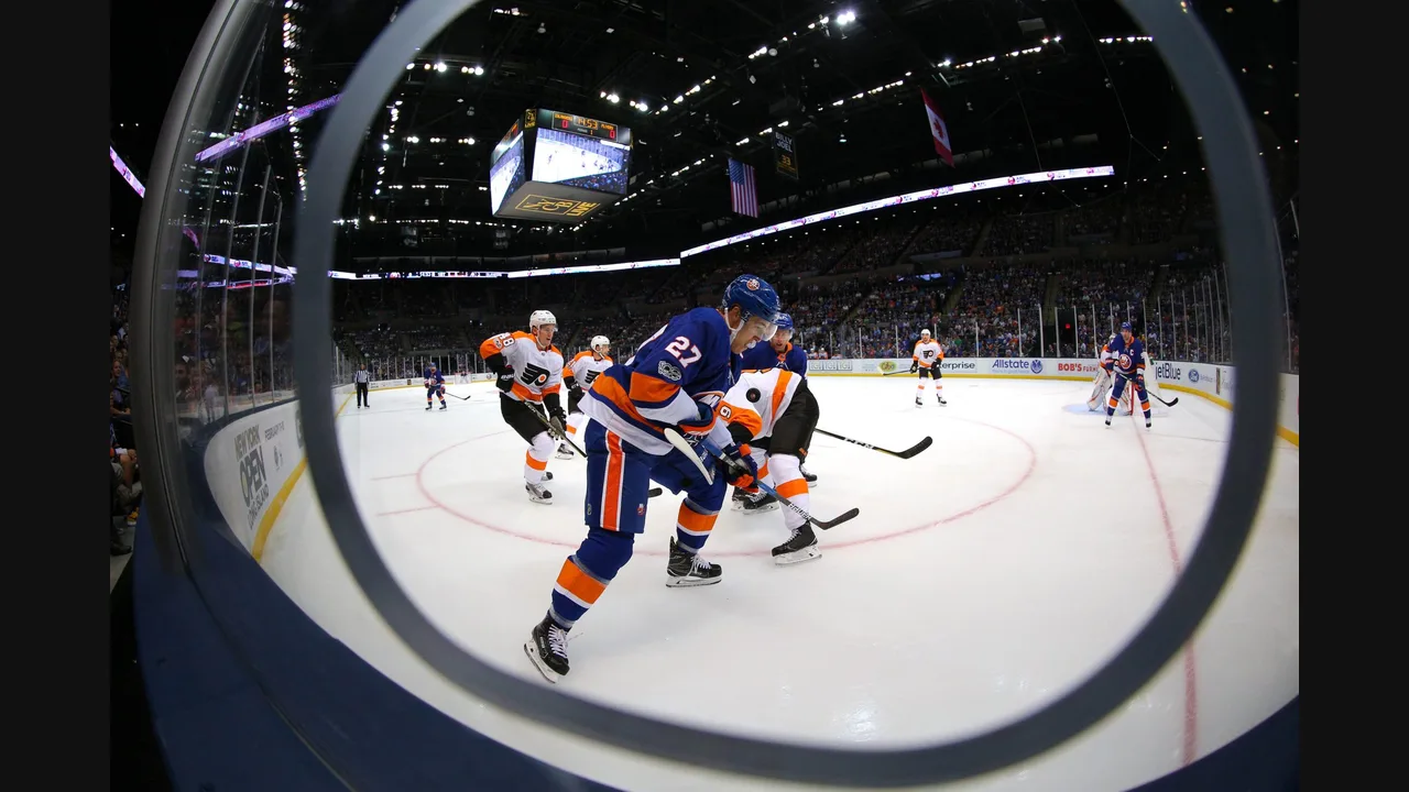 Photograph of Islanders and Flyers players battling for the puck, shot through the rink glass